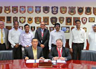 Terry McGowan, President and CEO, Thordon Bearings (seated right), and Mohammad Rizal (left), Chief Operating Officer of Drydocks World-Dubai, sign an agreement that affirms the two companies’ efforts to convert ships to seawater lubricated propeller shaft lines from oil
