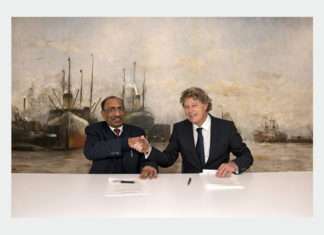 Captain Mousa Murad and Koen Overtoom shaking hands after signing the MOU between the two organisations