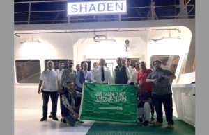The crew of Shaden celebrating the awarding of national flag status to the vessel