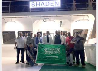 The crew of Shaden celebrating the awarding of national flag status to the vessel