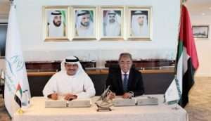 Khamis Juma Buamim, managing director and group chief executive of Gulf Navigation Holdings, with Wong Siew Cheong, executive chairman and chief executive of Atlantic Navigation, agree the provisional majority share purchase deal