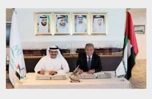Khamis Juma Buamim, managing director and group chief executive of Gulf Navigation Holdings, with Wong Siew Cheong, executive chairman and chief executive of Atlantic Navigation, agree the provisional majority share purchase deal
