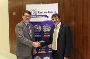 Kongsberg Marine’s Konrad Mech shakes hands with Harry Gandhi, chief executive of Unique Group
