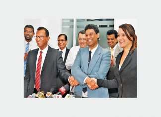 South Asia Gateway Terminals (SAGT) Operations General Manager, Upul Jinadasa, Sri Lanka Port Authority (SLPA) Director (Port Operations), Jayantha Perera, and Colombo International Container Terminals (CICT) Commercial and Marketing General Manager, Catriona Jayasundere, shake hands, while Ports and Shipping Minister, Mahinda Samarasinghe, and Sri Lanka Port Authority Chairman, Dr. ParakramaDissanayake, look on