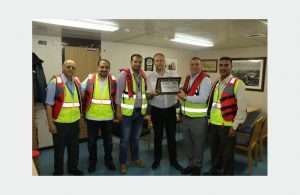 The captain of the MOL Garland receiving a plaque to mark its maiden call into ACT