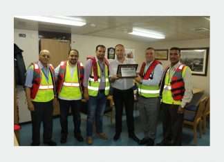 The captain of the MOL Garland receiving a plaque to mark its maiden call into ACT