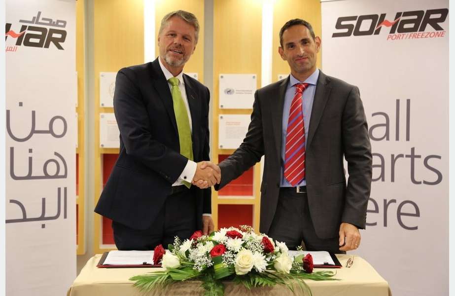 Mark Geilenkirchen, CEO, Sohar Port and Freezone shakes hands with Karim Cordahi, country manager, Svitzer Oman, after signing an agreement for Svitzer to supply and manage two new pilot vessels and provide round-the-clock operational support