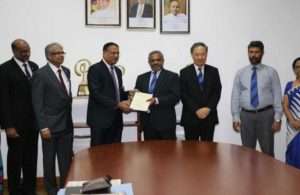 Kavan Ratnayaka, Chairman, SLPA, and D.V. Abeysinghe, Managing Director of Colombo Dockyard, exchanging contracts to build two new pilot boats
