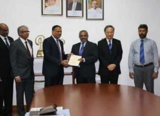 Kavan Ratnayaka, Chairman, SLPA, and D.V. Abeysinghe, Managing Director of Colombo Dockyard, exchanging contracts to build two new pilot boats
