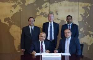Eugene Mayne (left) of Tristar and Greg Stevens signing the joint venture contract. Witnessing are Tristar officers Balaji Nagabhushan, Marco Bachechi and Sybi Kuruvilla Varghese