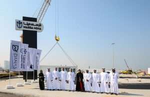 VIPs attend the start of work at Marsa Mina with the debut container in the background