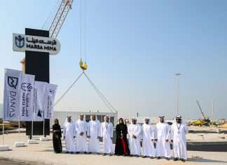 VIPs attend the start of work at Marsa Mina with the debut container in the background