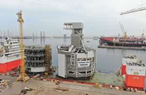 The TMS components being loaded onto a heavy lift vessel prior to departing Drydocks World