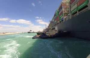 Tugs working to free the stricken container ship in the Suez Canal