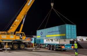 GAC staff unloading a container with sports and events equipment inside