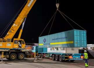 GAC staff unloading a container with sports and events equipment inside