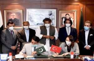 Representatives from Sanmar and Port Qasim Authority sign the contract for six new tugs