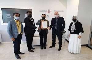 Robert Sutton, Head of Logistics Cluster, AD Ports Group, receiving the GDP Accreditation Certificate from Bureau Veritas’ representative in the presence of a number of the Group’s officials.