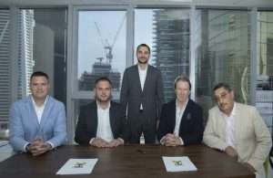 Mycrane founder Andrei Geikalo, standing, is pictured with new franchise partners following the signing of partnership agreements in Dubai