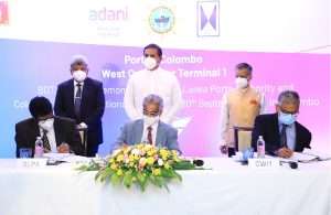Capt.Nihal Keppetipola and Upul Jayatissa sign the agreement on behalf of Sri Lanka Ports Authority (SLPA), with Capt.Sandeep Mehta and Krishan Balendra of Adani and John Keell Holdings respectively