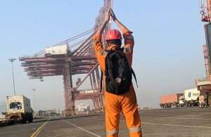 An APM Terminals Mumbai worker bidding farewell to one of the older container cranes, now being decommissioned